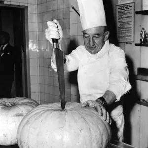 Print of a French chef chopping a large pumpkin Print of a French chef chopping a large pumpkin
