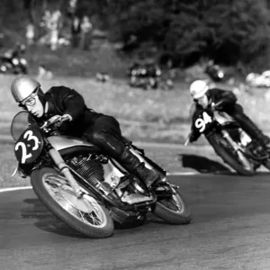 John Surtees compact crouch helps to streamline him at top speed. Here he corners