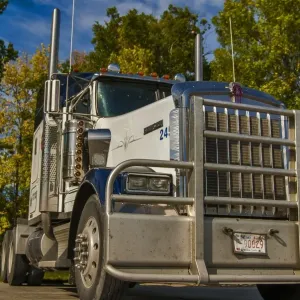 Kenworth 6x4 semi unit parked in the sun against gorgous autumn colours, taken Kenworth 6x4 semi unit parked in the sun against gorgous autumn colours, taken