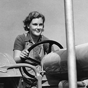 Land Girl driving a tractor during WW2 - a girl now in training for the Womens