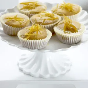 Lemon muffins with lemon zest glaze on white cakestand credit: Marie-Louise Avery Lemon muffins with lemon zest glaze on white cakestand credit: Marie-Louise Avery