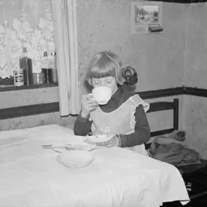 Little Ann Bowers at breakfast with her tame jackdaw, Eynsford, Kent Little Ann Bowers at breakfast with her tame jackdaw, Eynsford, Kent