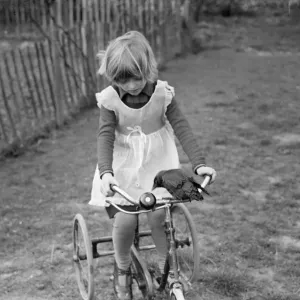 Little Ann Bowers playing on her tricycle with her tame jackdaw ringing the bell Little Ann Bowers playing on her tricycle with her tame jackdaw ringing the bell