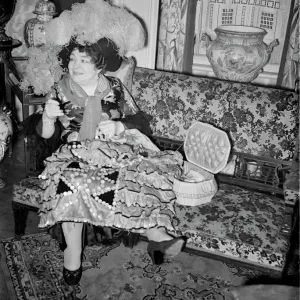 A black and white print of a woman preparing a dress at home