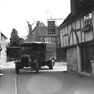 Lorry driving past Ye Old George In garage in Shoreham. 1934
