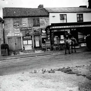 Print of a man on horseback in front of a Sevenoaks grocer's shop Print of a man on horseback in front of a Sevenoaks grocer's shop