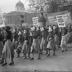 Print of women in paper gas masks arriving at Trafalgar Square
