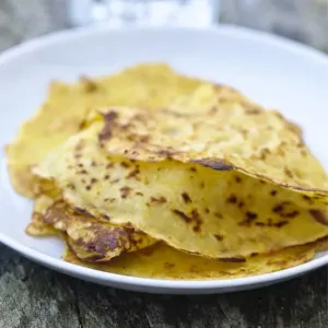 Mexican corn pancakes stacked on white plate credit: Marie-Louise Avery / thePictureKitchen
