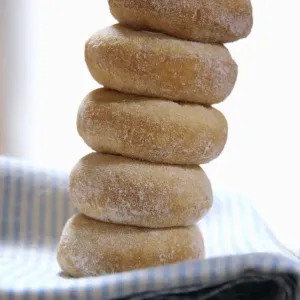 Mini ring doughnuts stacked on blue and white napkin credit: Marie-Louise Avery Mini ring doughnuts stacked on blue and white napkin credit: Marie-Louise Avery