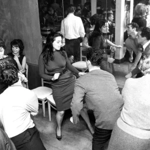 A mirror reflects the patrons in a night club dancing the twist dance / dancing / A mirror reflects the patrons in a night club dancing the twist dance / dancing /