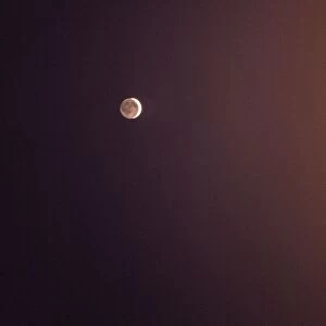 Moon in the night sky. Crescent moon with the reflection of sunlight thrown by the