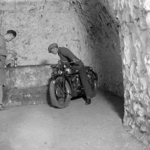 Motorcycle in caves at Chislehurst, Kent. Mushroom growing. 1934 Motorcycle in caves at Chislehurst, Kent. Mushroom growing. 1934