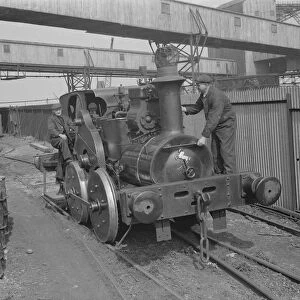 Mr F Tremain and Mr A Shoveller operating an old locomotive in Erith, London. 1939