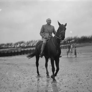 Mr Hore Belisha spends his holiday - on horseback. Away from transport problems Mr Hore Belisha spends his holiday - on horseback. Away from transport problems