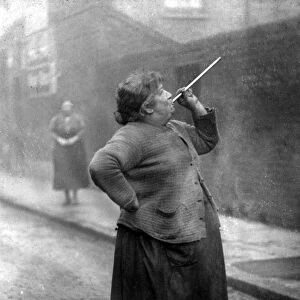 Mrs. Smith wakens the dockers of Limehouse, London, with her peashooter in 1927 TopFoto