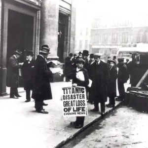 A newspaper boy spreads the news of the sing of the Titanic to bystanders outside A newspaper boy spreads the news of the sing of the Titanic to bystanders outside