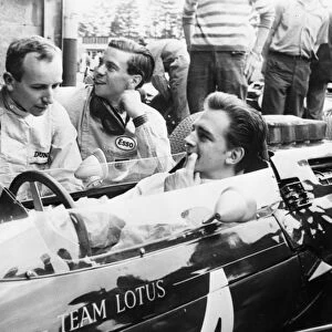 Nurburgring Lotus team driver Trevor Taylor gets some friendly advice from fellow