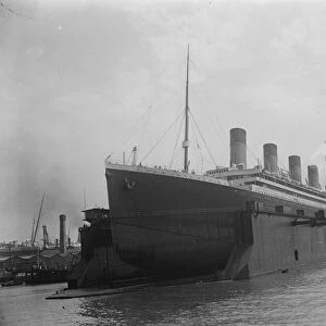 Olympic enters Southamptons huge floating dock. 12 July 1924