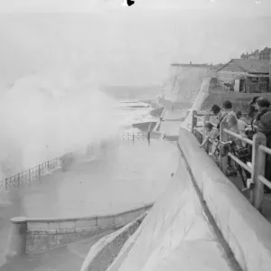 People running for shelter from great waves which broke over the seafront at Rottingdean People running for shelter from great waves which broke over the seafront at Rottingdean