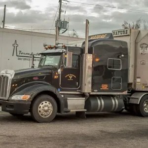 Peterbuilt 6x4 semi with a livestock trailer parked up on a service station SW of
