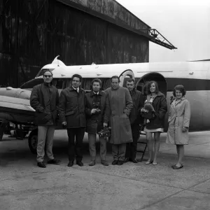 Black and white print of a team in front of an aircraft Black and white print of a team in front of an aircraft
