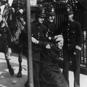 Political - four policemen, one mounted, arrest a suffragette Political - four policemen, one mounted, arrest a suffragette