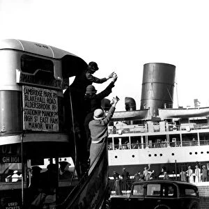 The public waving off a ship from a passing bus