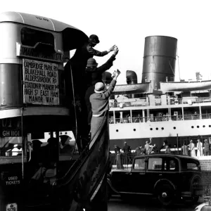 Print of a bus passing by a ship being waved off Print of a bus passing by a ship being waved off