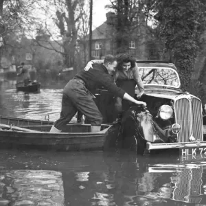 Print of a flooded road in Maidenhead with rescue by boat Print of a flooded road in Maidenhead with rescue by boat