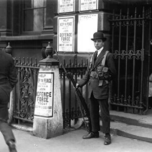 Royal Defence Force Sentry at Somerset House 1921 in front of posters offering good pay