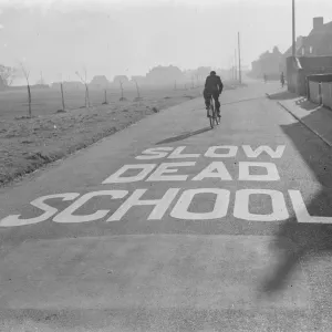 A school sign painted on the road warning road users they are approaching a school area A school sign painted on the road warning road users they are approaching a school area