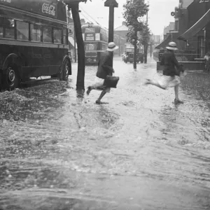 Schoolchildren running through floods at Forest Road junction, Walthamstow. Print Schoolchildren running through floods at Forest Road junction, Walthamstow. Print