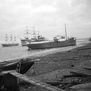 Shipping run aground on the shore in front of HMS Worcester and The Cutty Sark