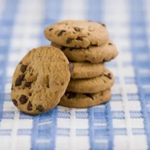Stack of chocolate chip cookies from supermarket credit: Marie-Louise Avery / thePictureKitchen