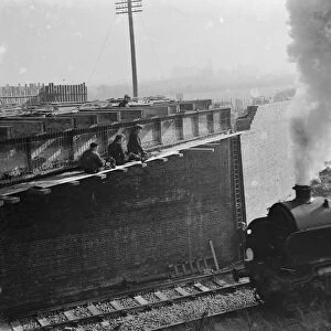 Steam engine passing by the building work being carried out for the widening of the