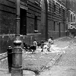 Toddlers & small chidren playing in the street by the docks in London. 1933