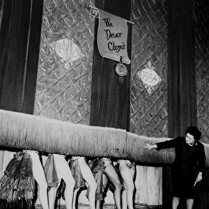 Windmill Theatre Owner Miss Sheila Van Dam watches as the curtain comes down over