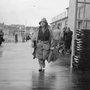 Women angler defies the gales at Hastings. With a stiff gale whipping up the sea Women angler defies the gales at Hastings. With a stiff gale whipping up the sea