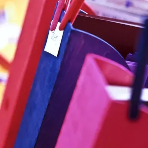 Wooden magazine or literature files stained in bright colours, labelled with wooden