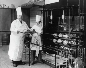 A. H. Cadier, senior chef at the Brighton Pavilion is handed fake chickens by junior