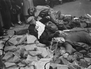 Air Raid Precaution exercise on Old Kent Road in London. Spectators look on as