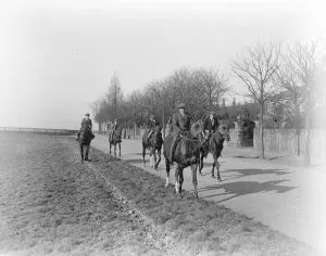 Riders Prints: Americas boy leading Felix Leachs string of horses at Newmarket. 1924