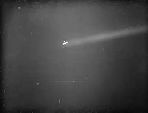 An anti aircraft display in Dartford, Kent. An aeroplane is caught by a searchlight