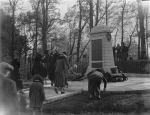 Armistice memorial service in Sidcup, Kent. A lady lays a wreath at the foot