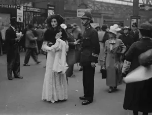 Passengers Prints: Asking a policeman at Waterloo. Mrs Challenor Lynch asking a policeman for