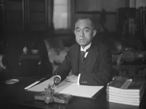 Baron Matsui posed at desk. 1925