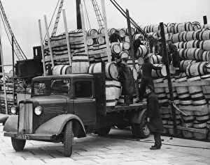 Port Collection: Barrels for the Shetland catch of herring being unloaded at Lerwick, 1949