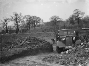 A Bedford truck, full of soil, pulls out of the site where the new swimming pool