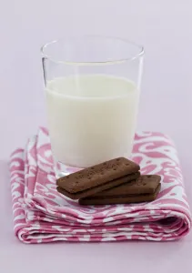 Glass Prints: Bedtime snack of a glass of cold fresh milk with bourbon chocolate biscuits credit