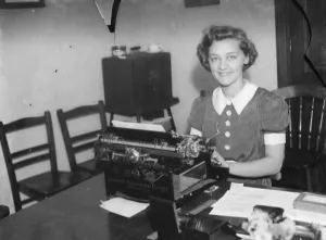 The Bexleyheath Gala Queen, Miss Dorothy Gardner, sitting at a typewriter. 1939